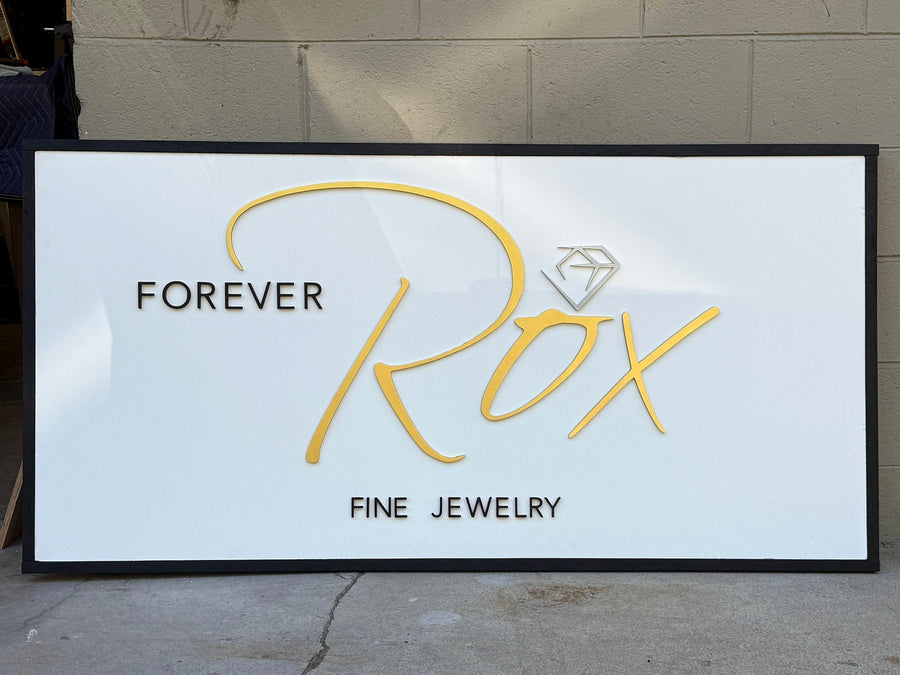 Finished Forever Rox Fine Jewelry sign in a black frame