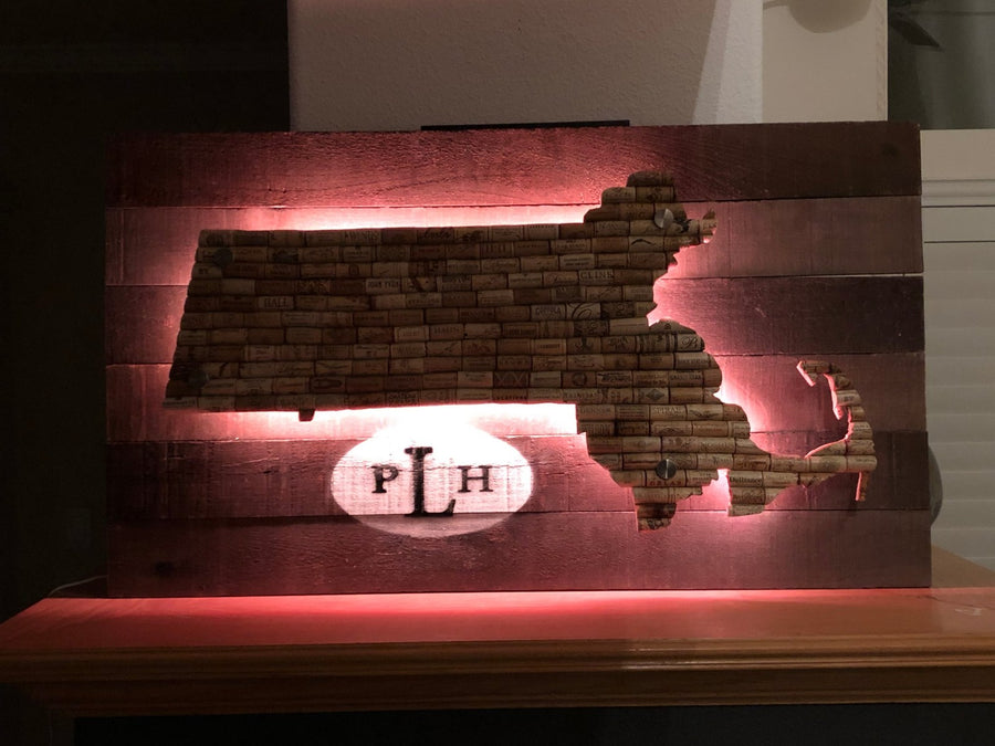 Cork map sign glowing pink from LEDs mounted behind the map