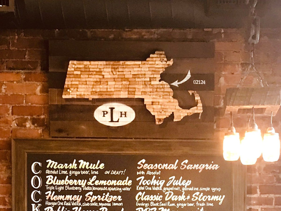 Cork map sign installed on the brick wall at Landmark Public House above the cocktail board
