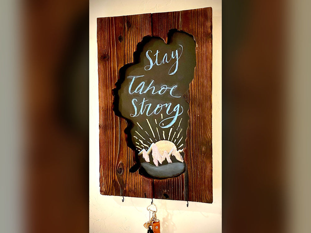 Barn wood sign with a Lake Tahoe-shaped chalkboard reading Stay Tahoe Strong, with key hooks along the bottom